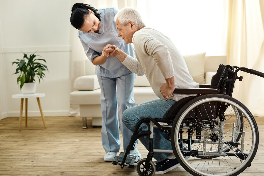 maid taking care of a main in wheelchair